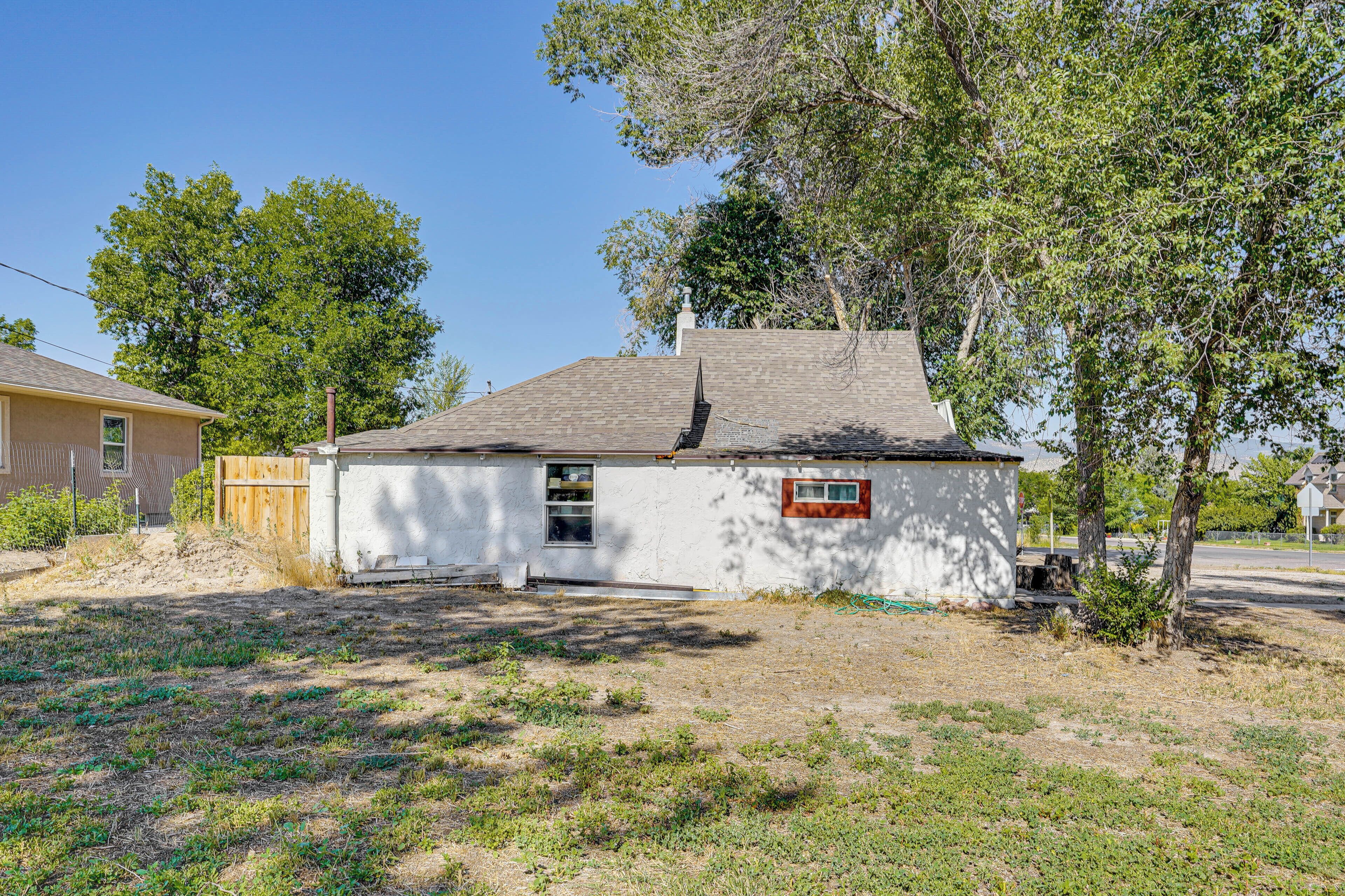 A small, single-story house with a sloped roof, a front door, and a small porch area.