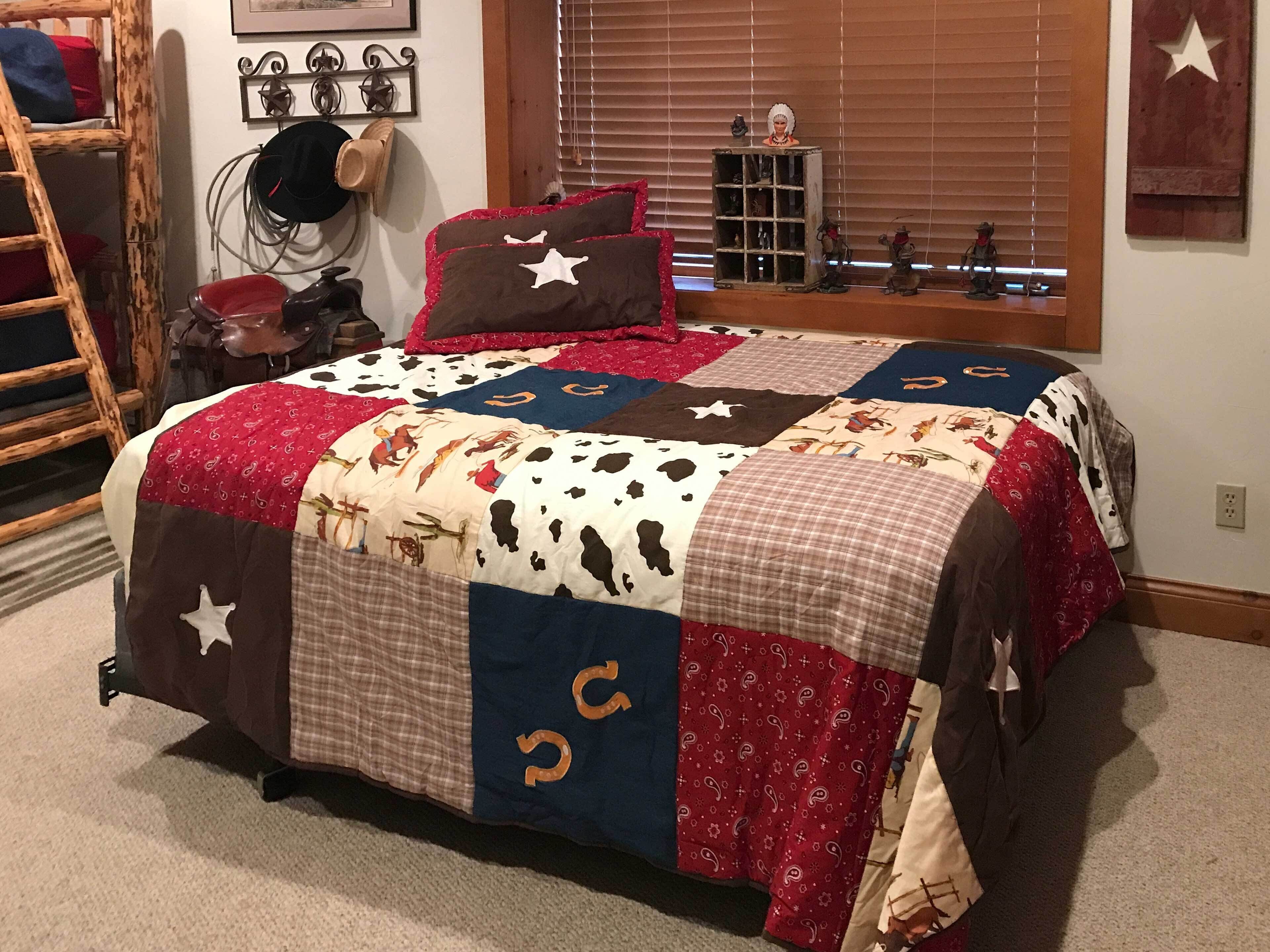 A bedroom with a large bed, a wooden ladder, a hat on the wall, and a window with blinds.