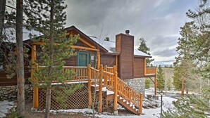 A log cabin with a wooden deck, stone foundation, and a chimney. - 2 Mi to Skiing: Mtn-view Home w/ Deck in Granby! (Granby)