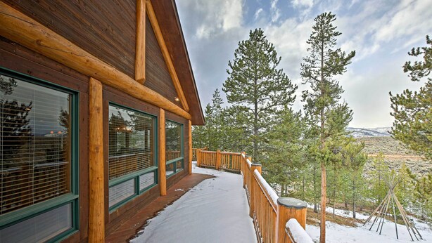 A wooden cabin with large windows and a snow-covered deck. - 2 Mi to Skiing: Mtn-view Home w/ Deck in Granby! (Granby)