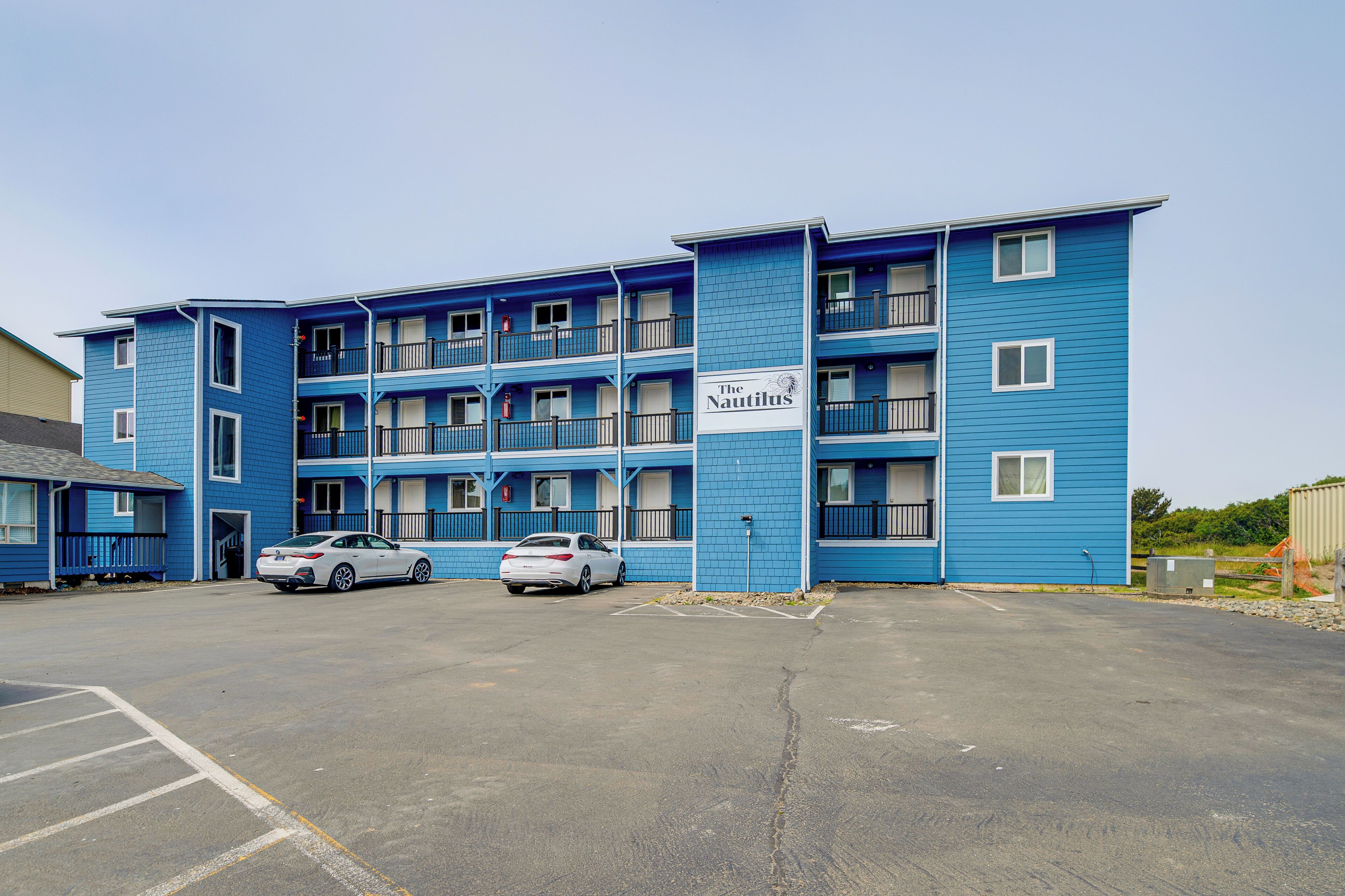 A blue multi-story building with a sign reading "The Nautilus."