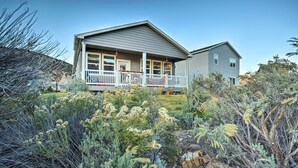 A two-story house with a covered porch and a small detached garage. - Magnificent Gypsum Retreat on the Colorado River! (Gypsum)