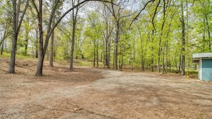 A campground with a dirt path leading to a small building, surrounded by trees. - Arkansas Vacation Rental < 1 Mi to Norfork Lake (Mountain Home)