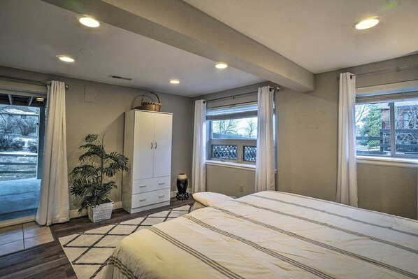 A bedroom with a large bed, a wardrobe, a potted plant, and a window with curtains. - 6 Mi to Dtwn Parker: Serene Studio Suite! (Parker)