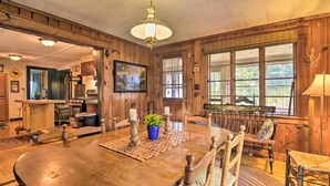 A wooden dining room with a large table, chairs, and a chandelier. - Rustic Roxbury Ski Farmhouse With Trails! (Roxbury)