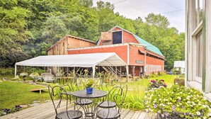 A wooden deck with outdoor furniture and a white canopy. - Rustic Roxbury Ski Farmhouse With Trails! (Roxbury)