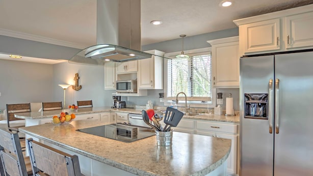 A modern kitchen with white cabinets, stainless steel appliances, and a granite countertop. - Monticello Home w/ Multi-level Deck on 2 Acres! (Monticello)