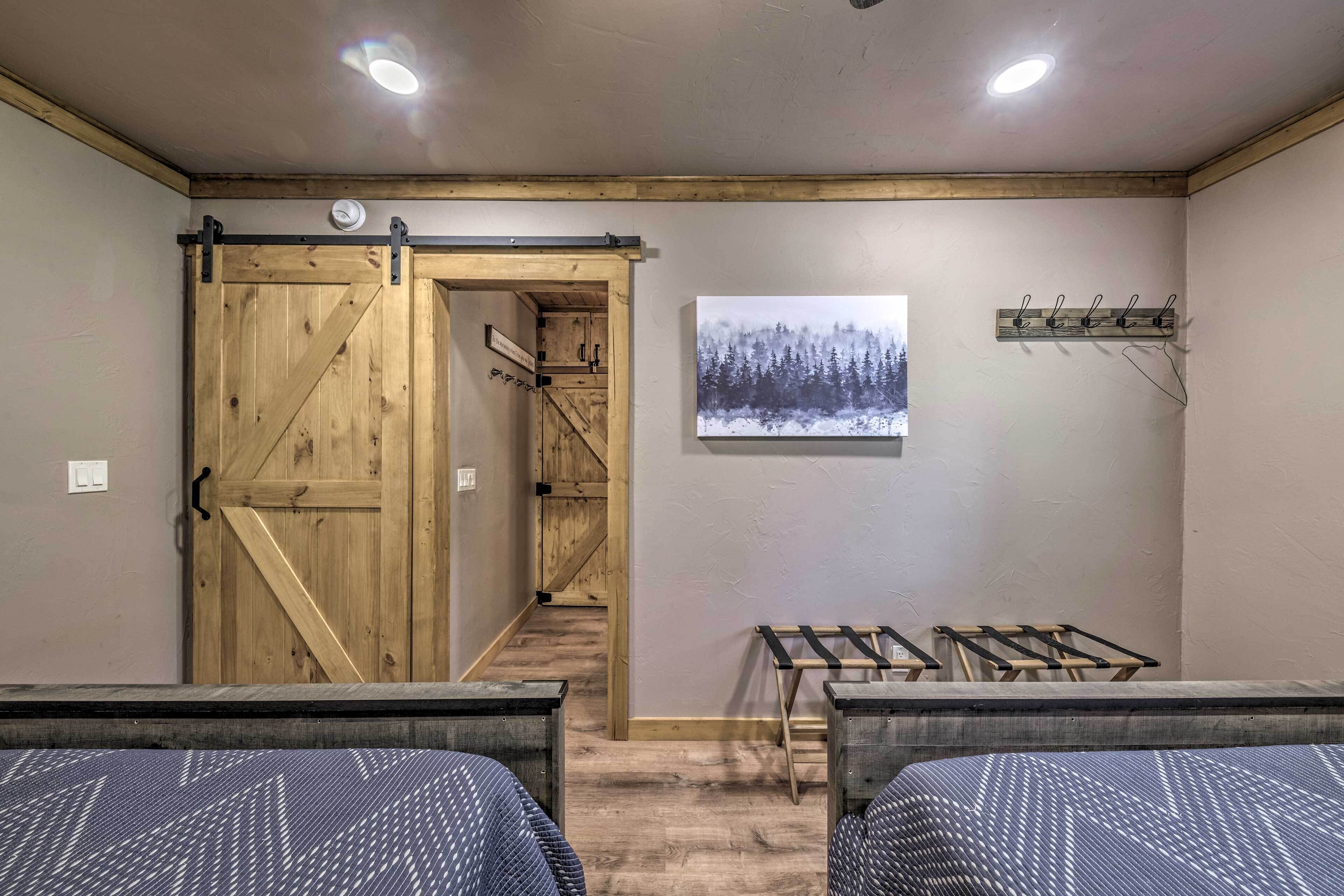 A room with a wooden door, a coat rack, and a framed picture on the wall.