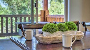A wooden table with a woven tray holding two potted plants, two white mugs, and a wooden bowl. - Spacious Resort Cabin in Manti-la Sal Mtns! (Fairview)