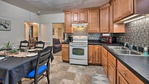 A kitchen with wooden cabinets, a stove, a microwave, and a sink. - Stevens Vacation Rental ~ 14 Mi to Lancaster (Stevens)