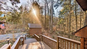 A wooden deck leading to a cabin surrounded by trees. - 'timberland Estates' Cabin: Close to Trails! (Reedsville)