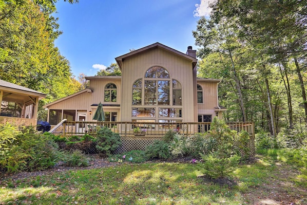 A large, two-story house with a prominent arched window and a covered porch.