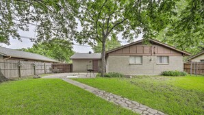 A residential property with a stone pathway leading to a house with a brick exterior and a brown roof. - Home 1 Mi to University of Texas: Relax Fireside! (Richardson)
