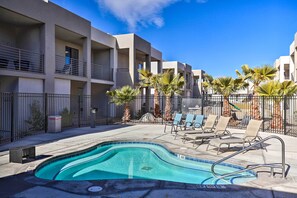 A modern hotel with a swimming pool, lounge chairs, and palm trees. - Sunny Resort Townhome + Balcony & Pool Access (St. George)
