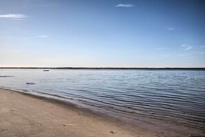 A beach with calm water and a clear sky. - Waterfront Home w/ Large Deck + Private Pool! (Westhampton Beach)