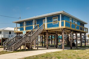 A two-story building with a wooden deck and stairs. - Waterfront Dauphin Island Home w/ Deck & Boat Dock (Dauphin Island)