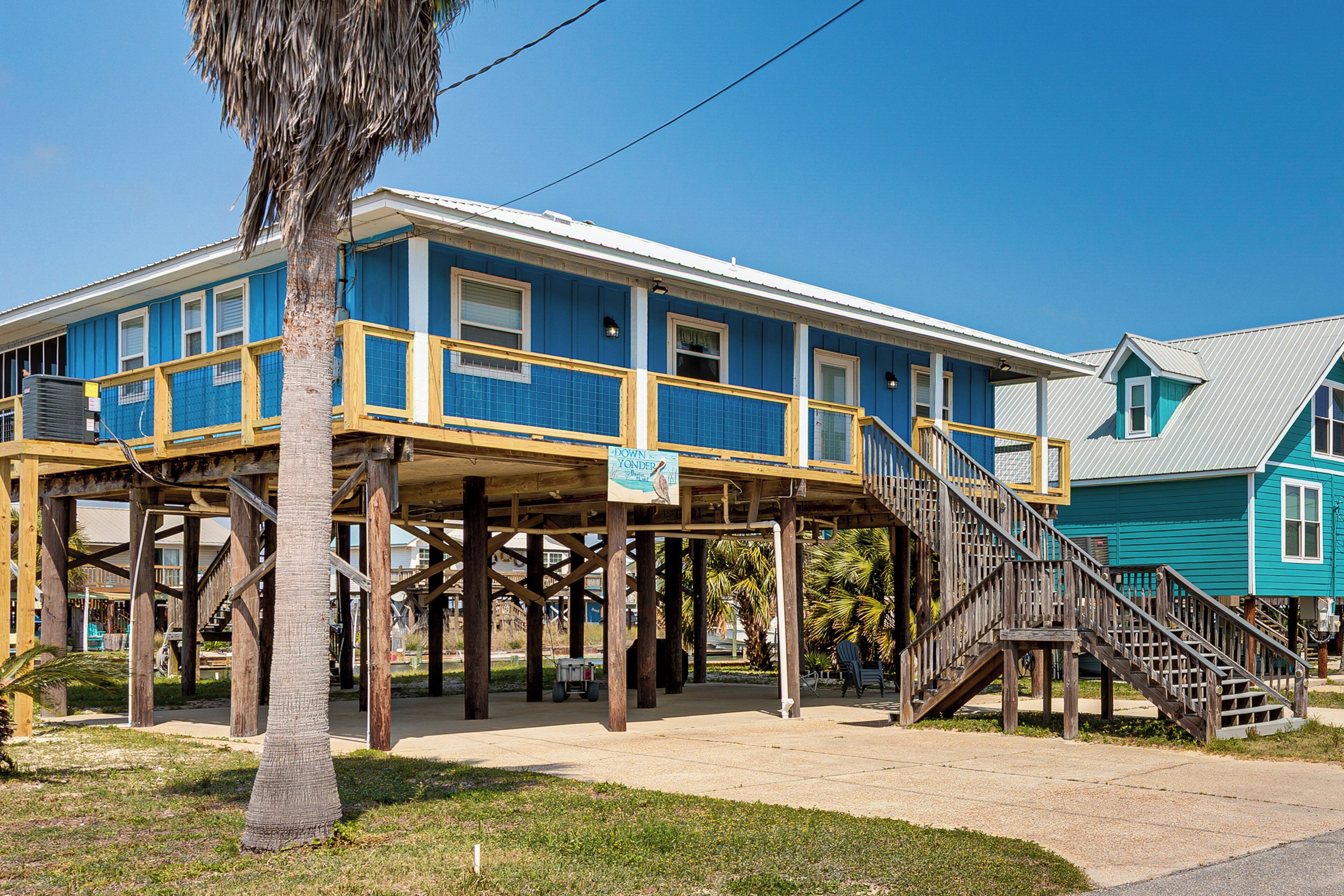A two-story building with a wooden deck and stairs leading to the second floor.