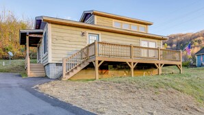 A two-story house with a wooden deck and a small porch. - Waynesville Cabin Rental w/ Mountain Views (Waynesville)
