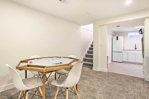 A modern kitchen with white cabinets, a refrigerator, and a microwave. - Bright & Modern Arvada Home w/ Yard & Patio (Westminster)