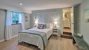 A bedroom with a bed, bedside tables, a dresser, and a view of the bathroom. - Newly Renovated Penn Yan Apartment < 1 Mi to Lake! (Penn Yan)