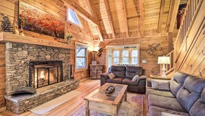 A log cabin interior with a stone fireplace, a leather sofa, and a wooden coffee table. - 4 Mi to Sugar Mtn: 'rocky Creek Cabin' w/ Hot Tub (Banner Elk)