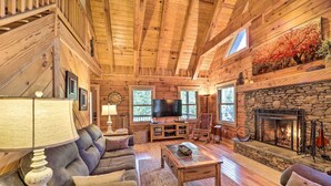 A cozy log cabin interior with a stone fireplace, leather sofas, a television, and a wooden ceiling. - 4 Mi to Sugar Mtn: 'rocky Creek Cabin' w/ Hot Tub (Banner Elk)