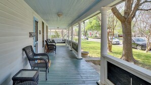 A covered porch with wicker furniture, a fireplace, and a view of the street. - Charming Georgetown Home - Walk to Downtown! (Georgetown)