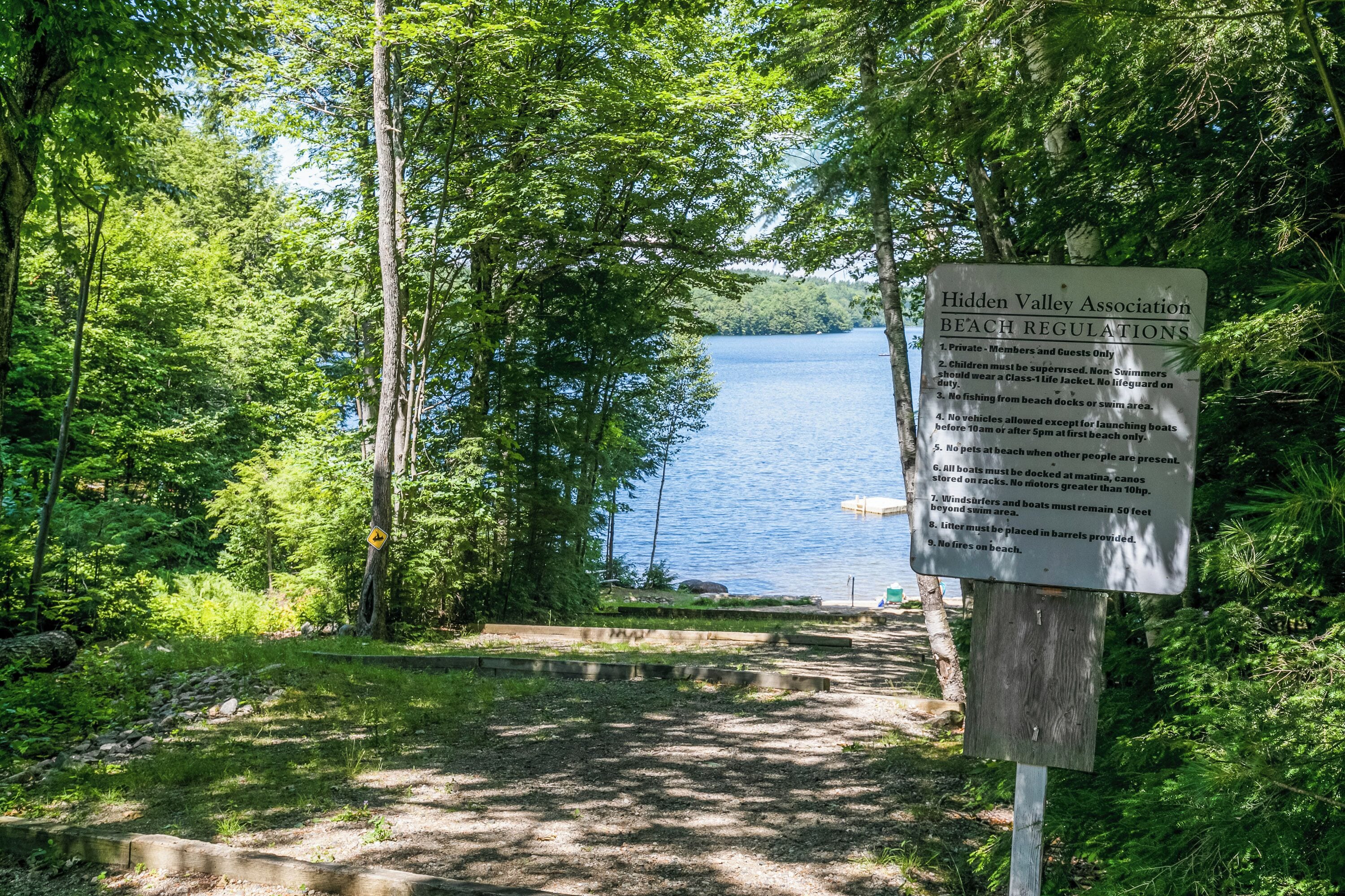 A sign listing Hidden Valley Association beach regulations.