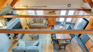 A loft-style living space with a dining area, kitchen, and seating area.