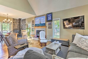 A spacious living room with a fireplace, comfortable seating, and a large TV. - Pet-friendly Grand Pine Bush Retreat on 2 Acres! (Pine Bush)