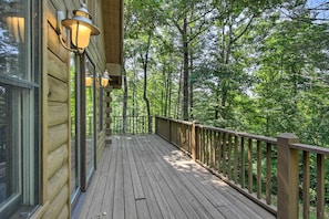 A wooden deck with glass doors and windows, surrounded by a wooden railing, overlooking a forested area. - 11 Mi to Calaboose Cellars: Marble Cabin w/ Deck! (Marble)