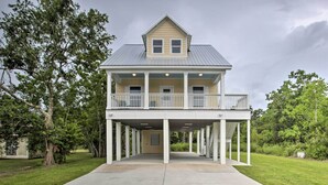 A two-story house with a balcony, a covered porch, and a front entrance.