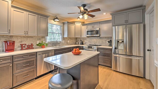 A modern kitchen with stainless steel appliances, a central island, and a ceiling fan. - Peaceful Country Retreat w/ Easy Highway Access! (Browns Summit)