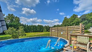 A swimming pool with a hot tub, surrounded by a wooden deck and a wooden fence. - Peaceful Country Retreat w/ Easy Highway Access! (Browns Summit)