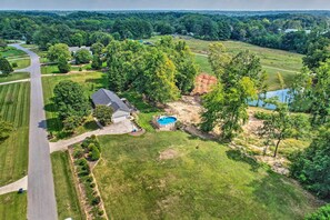 An aerial view of a residential area with a house, swimming pool, and surrounding greenery. - Peaceful Country Retreat w/ Easy Highway Access! (Browns Summit)