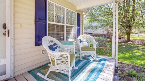 A porch with two wicker rocking chairs, a blue door, and a white railing. - Tracy City Home Near South Cumberland State Park! (Tracy City)