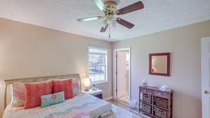 A bedroom with a bed, a ceiling fan, a nightstand, a dresser, and a window. - Tracy City Home Near South Cumberland State Park! (Tracy City)