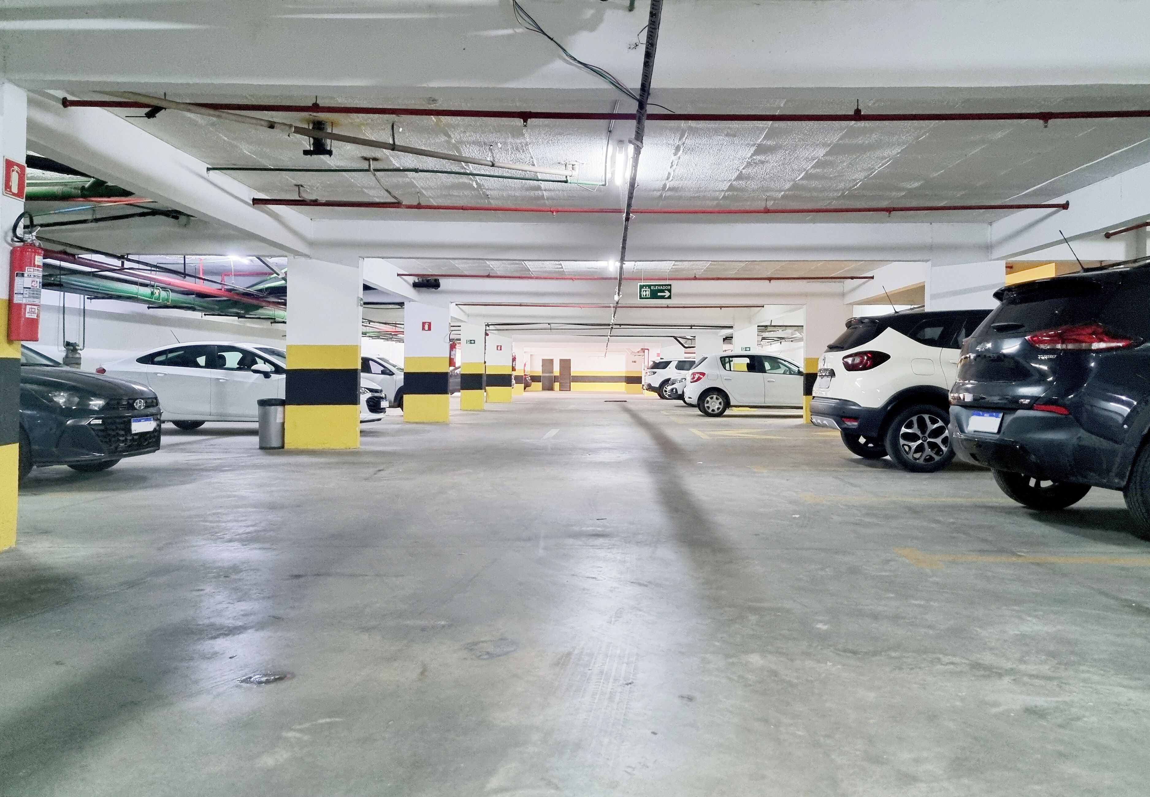 A multi-level parking garage with several cars parked.