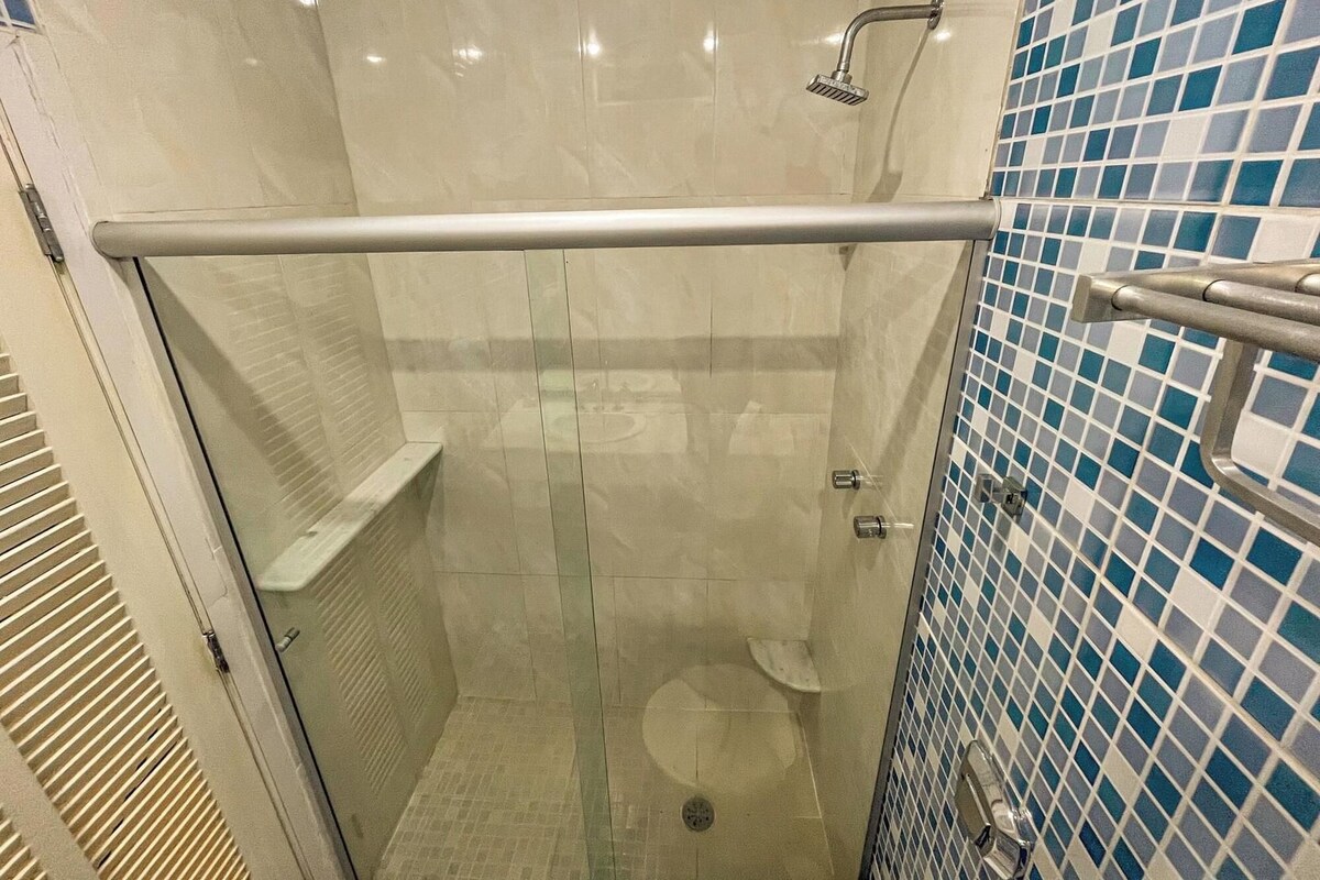 Bathroom | Shower, rainfall showerhead, hair dryer, towels