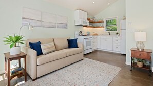 A modern kitchen with white cabinets, a built-in oven, and a window above the sink. - Comfortable Montecito Studio Cottage Walking Distance to Beach! (Santa Barbara)