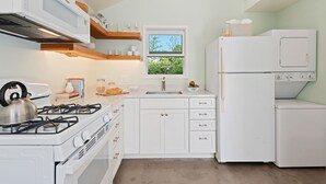 A modern kitchen with white cabinetry, a gas stove, a sink, and a built-in oven. - Comfortable Montecito Studio Cottage Walking Distance to Beach! (Santa Barbara)