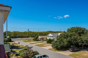 A residential area with houses, a clear sky, and a road.