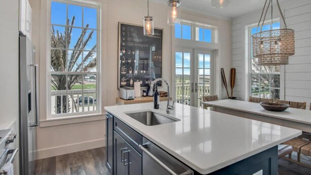A modern kitchen with a large island, stainless steel appliances, and pendant lighting. - Shared Heated Pool, Golf Cart Boardwalk to Beach (Port Aransas)