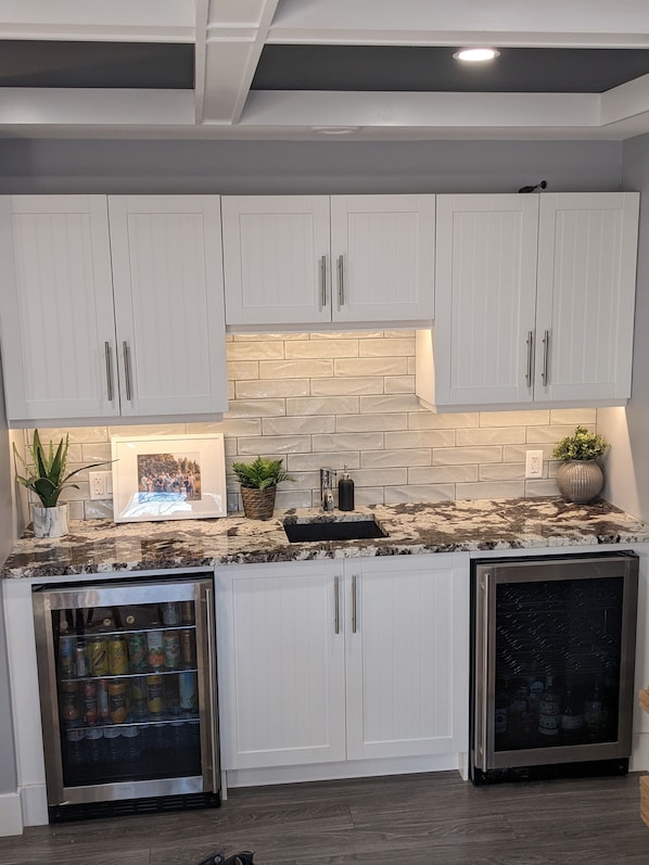 Enjoy cooking in this kitchen with wine cooler and stainless steel dishwasher.