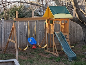 Children can play on the swing set, slide, and in the playhouse.