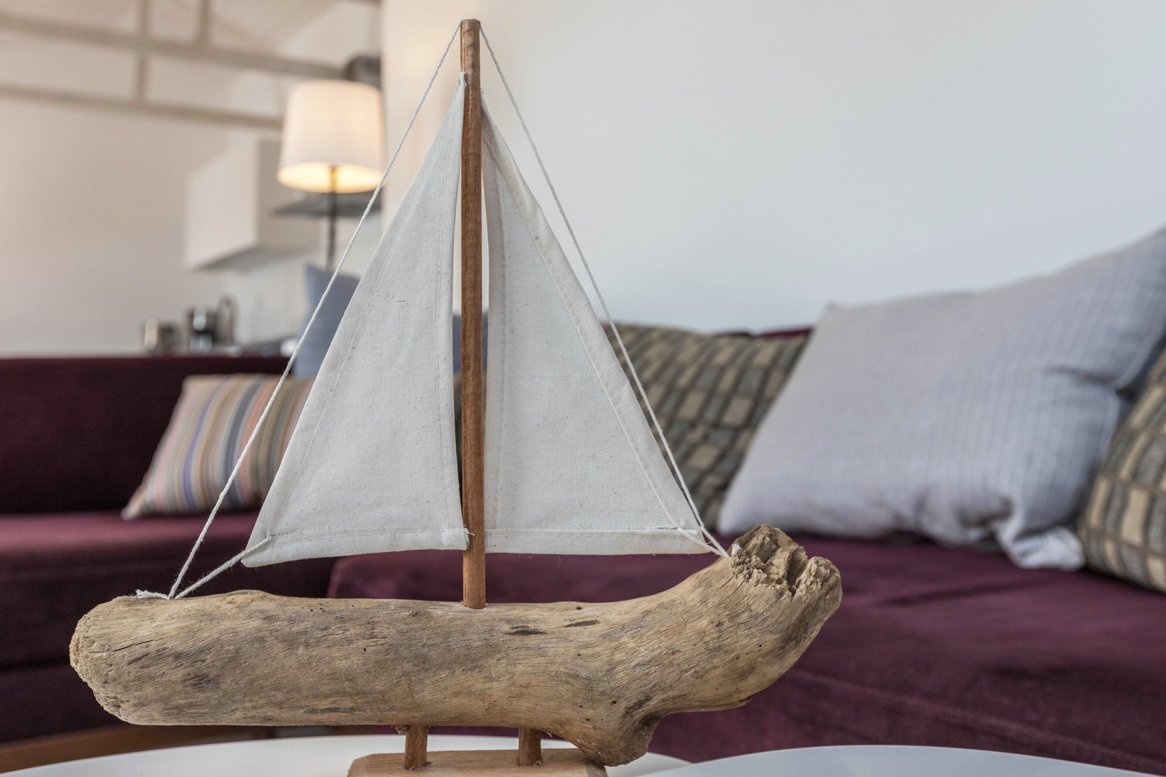 A model sailboat on a wooden base.