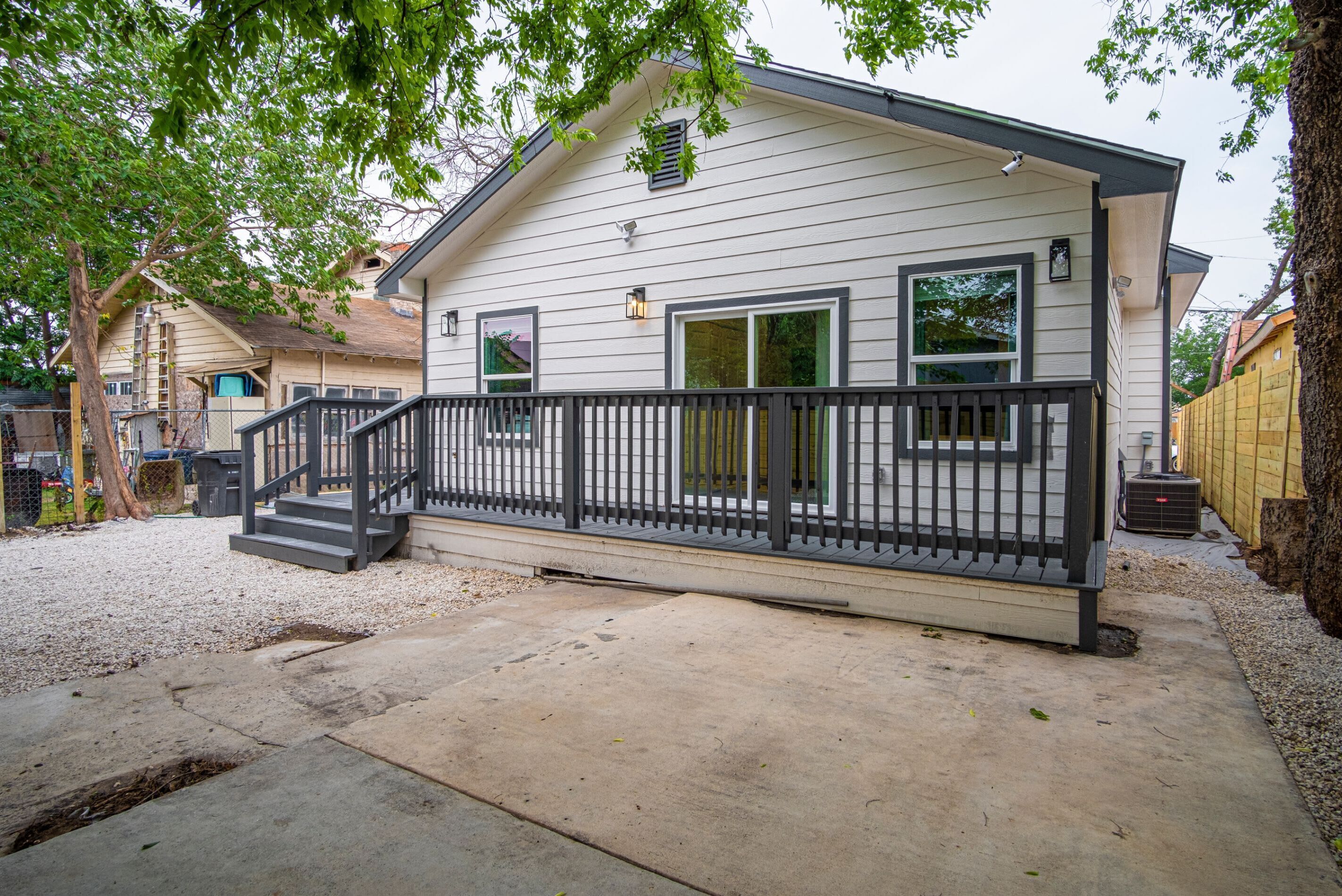 A single-story house with a covered porch and a small staircase leading to the entrance.