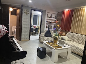 Standard Apartment, 1 Bedroom, Garden View | Living area | Plasma TV, fireplace, DVD player, MP3 dock - Mimihouse (Tbilisi)