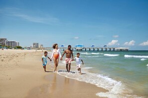 A beach scene with a pier in the background.