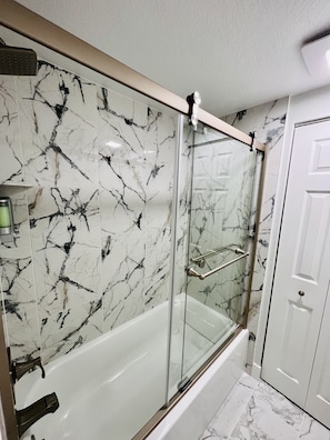 Shower, hair dryer, towels, soap - Beautifully Renovated 5-Bedroom Ranch Home in Prime Aurora Neighborhood (Aurora)